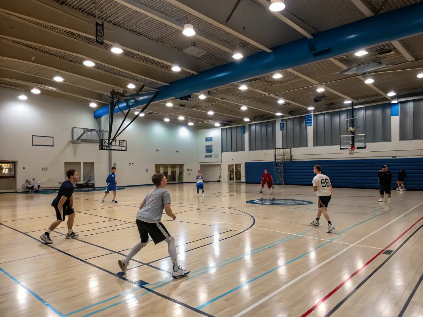 A group of students playing basketball in a school gymnasium, showcasing teamwork and sportsmanship.